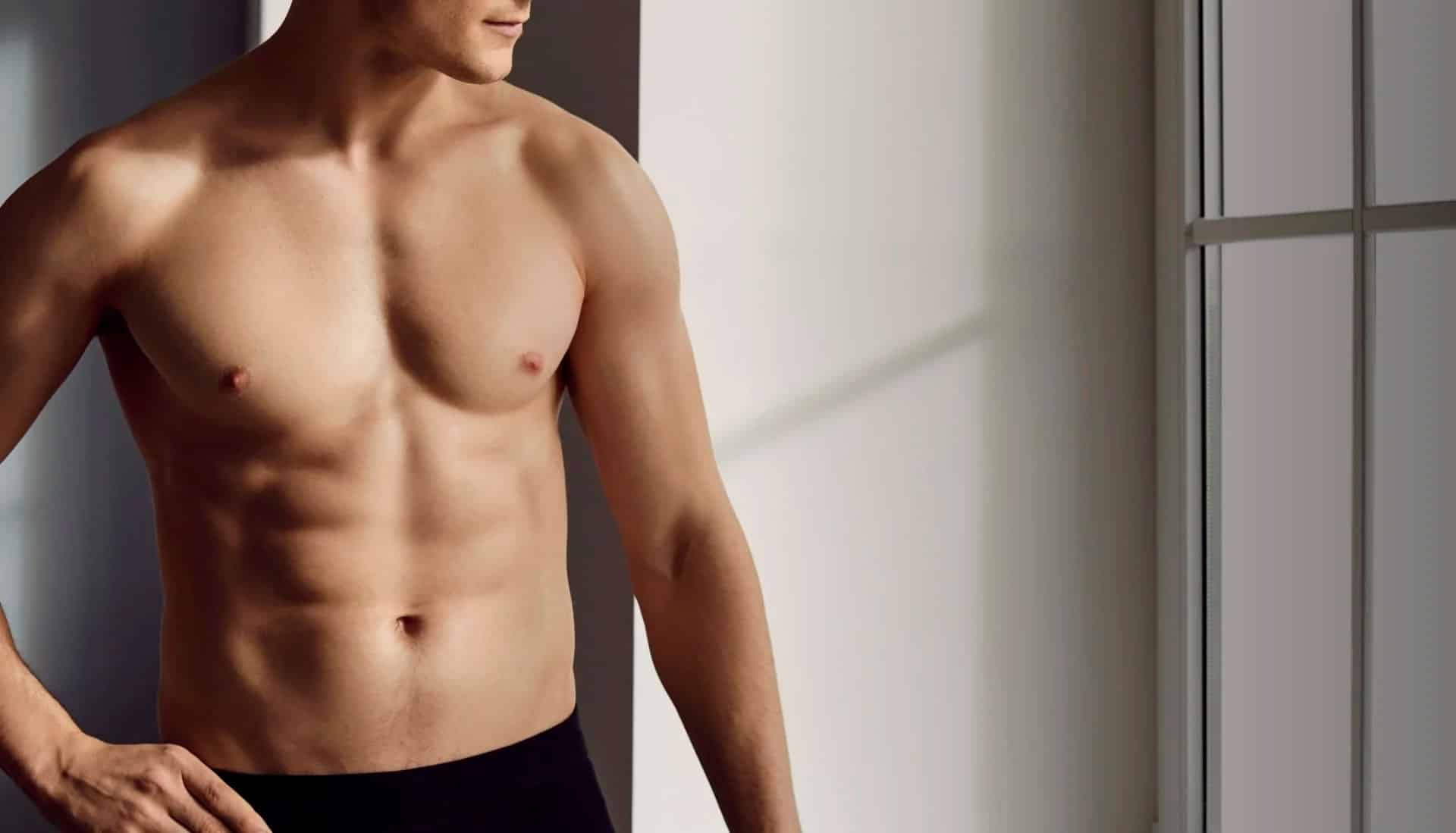 Professional male patient consultation with Dr. Hall discussing male liposuction areas